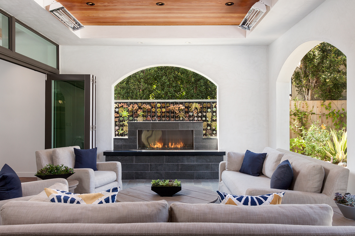 covered patio with fireplace and outdoor couches
