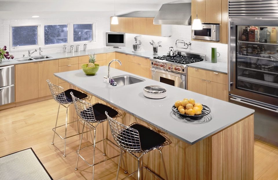 bright white contemporary kitchen with stainless steal appliances and greyish white countertops