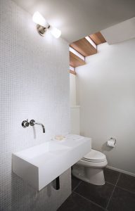 white contemporary bathroom with dark grey tiled floors