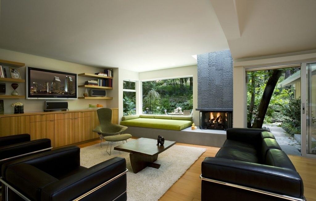 greencraig living room with black couches, tv, and a green chair